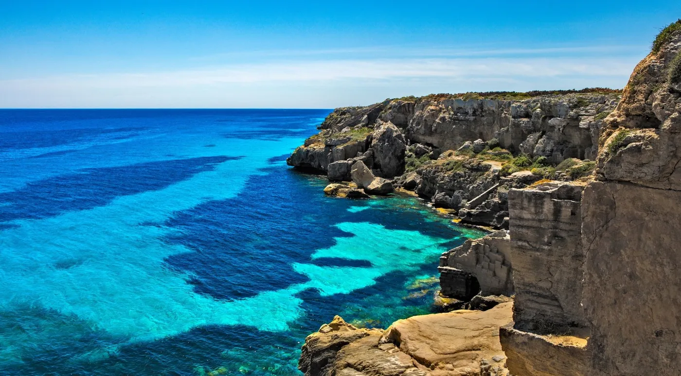 Turquoise water against the limestone cliffs of Cala Rossa on Favignana