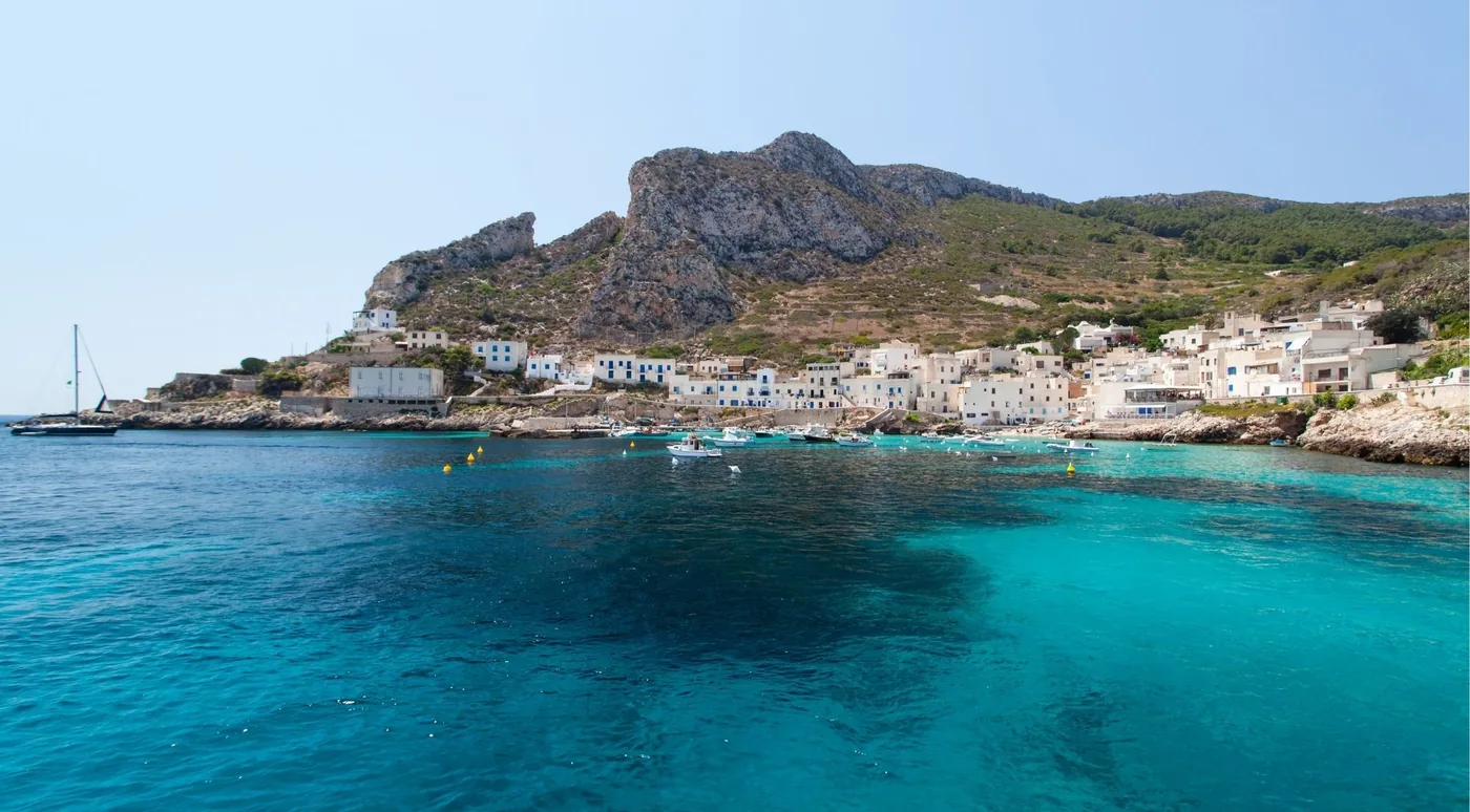 Levanzo village and its headland seen from the water on the approach by boat
