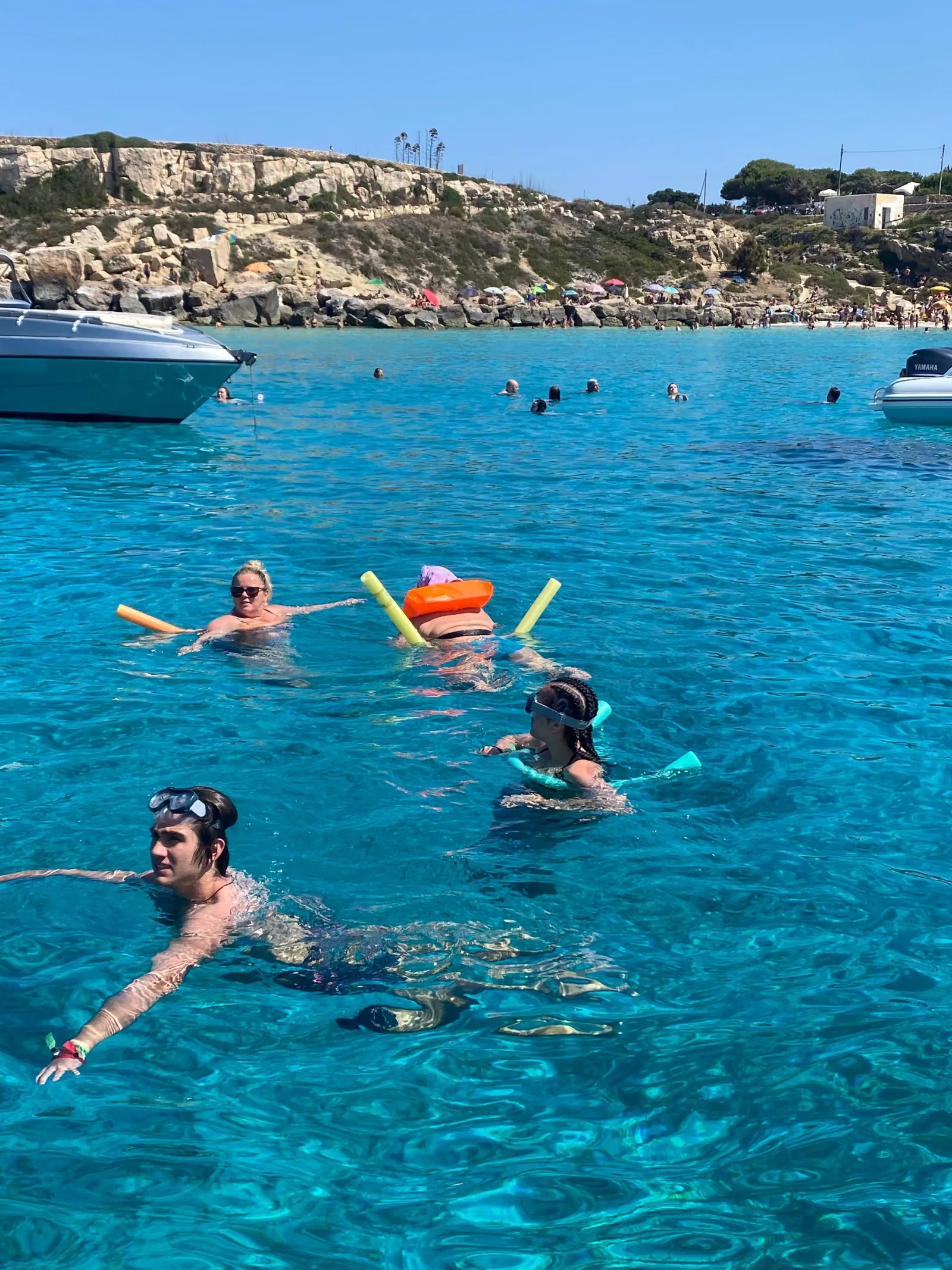 Guests swimming and snorkelling with floats at an anchorage
