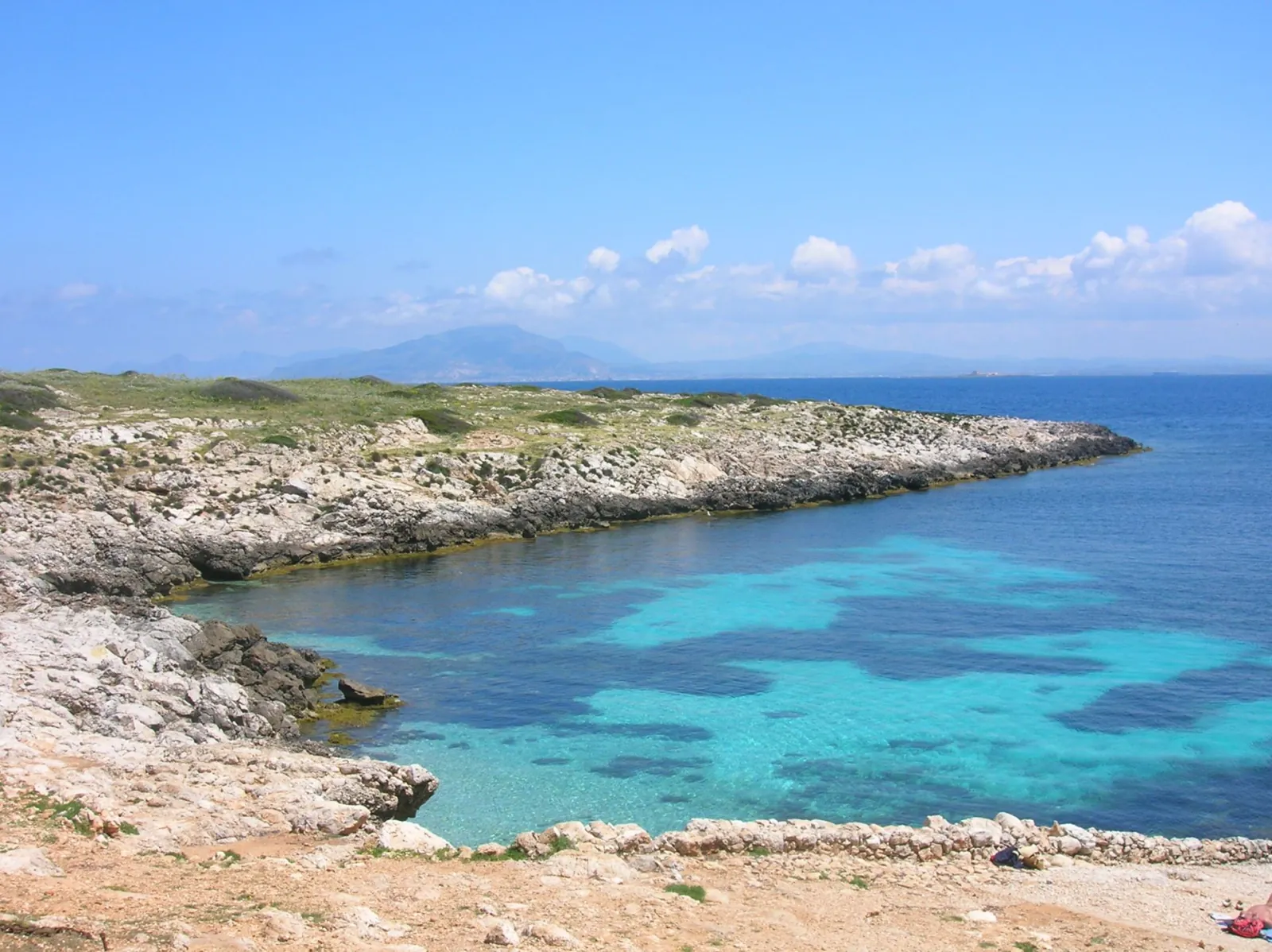 The low rocky coastline of Levanzo with shallow turquoise water running along the shore