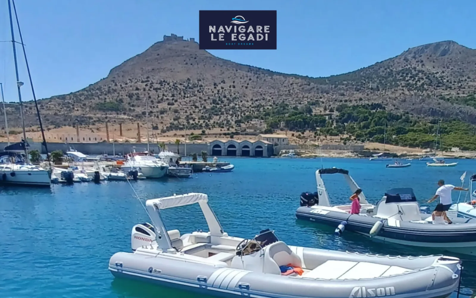The dinghy moored at Favignana harbour below Monte Santa Caterina