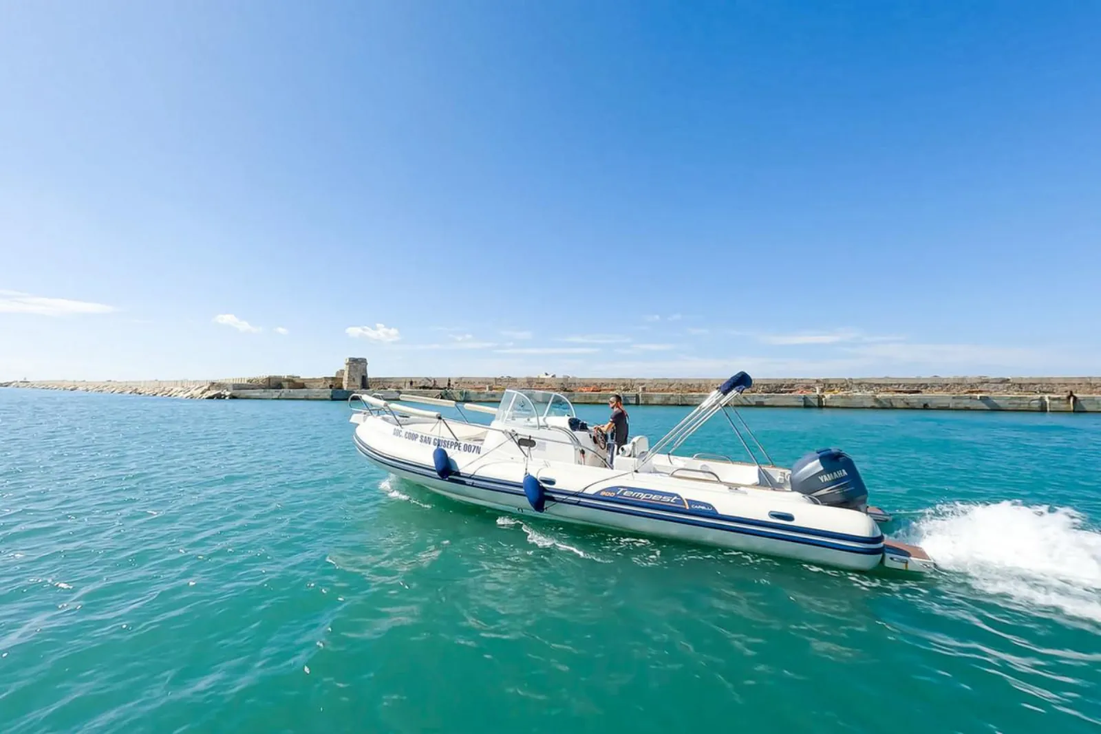 The rigid inflatable under way past the breakwater at Trapani port