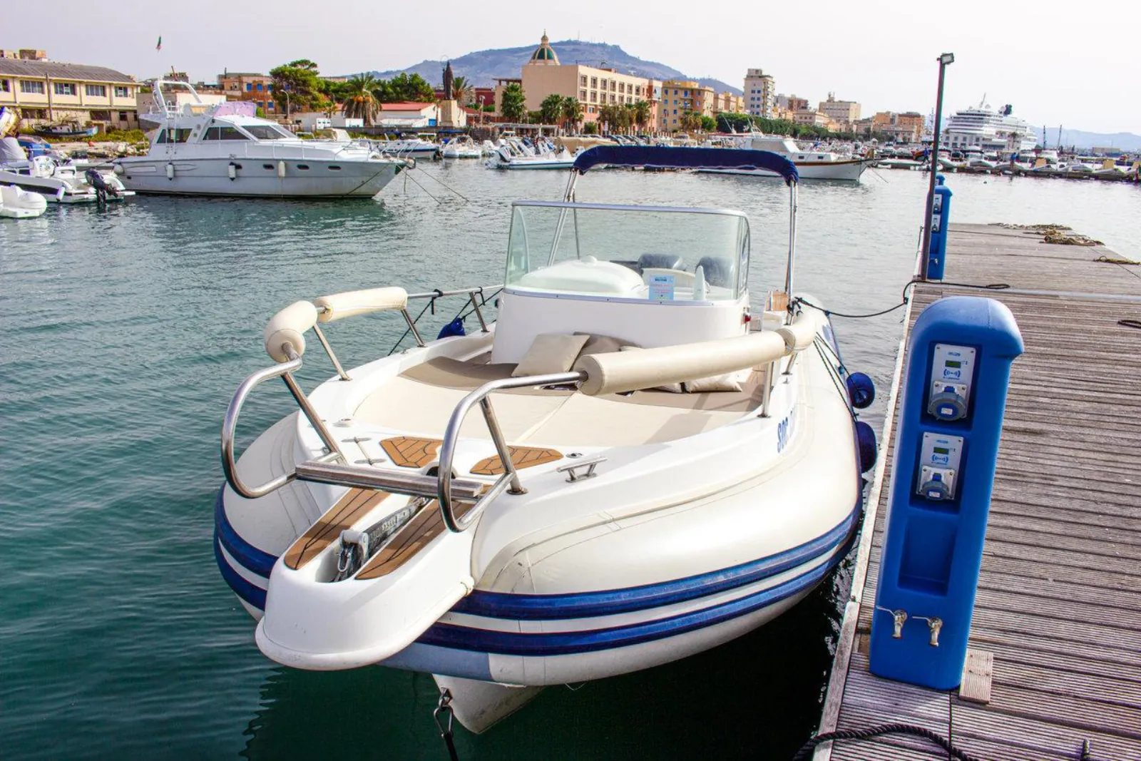 Two of the operator's boats moored bow-in at the marina pontoon