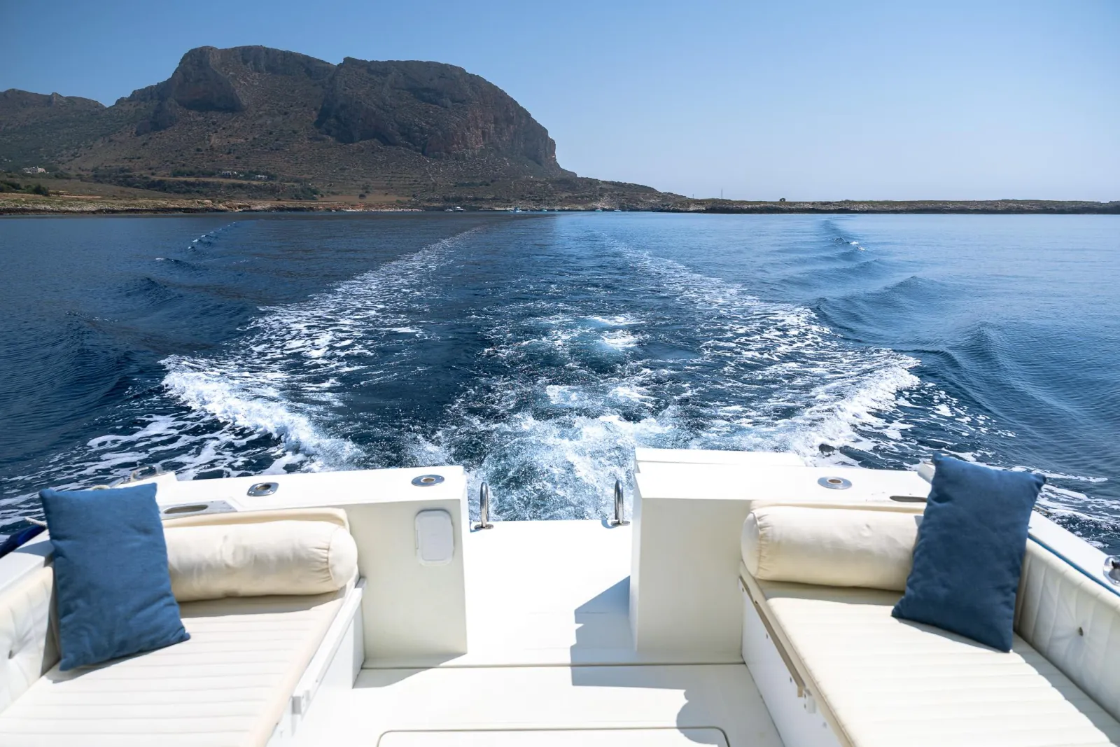The cushioned aft deck with the boat's wake running astern