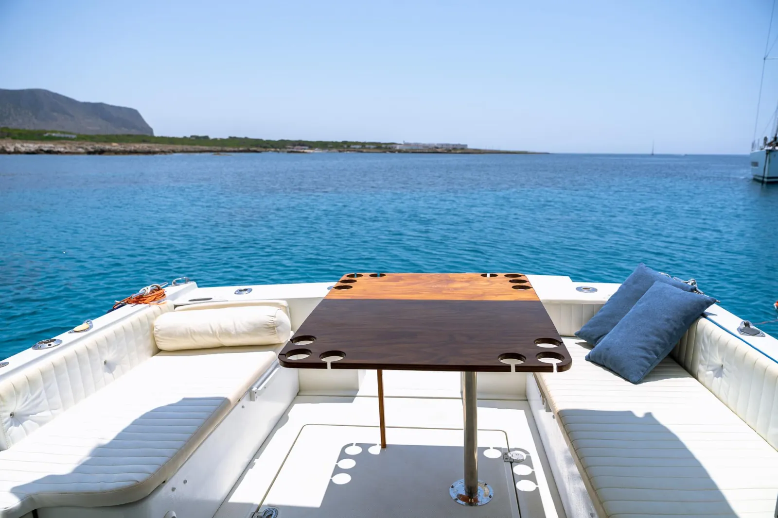 The teak table and seating set up on the aft deck for lunch